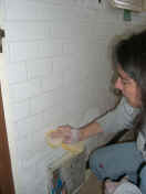 Bernadette wiping off the excess grout (296278 bytes)